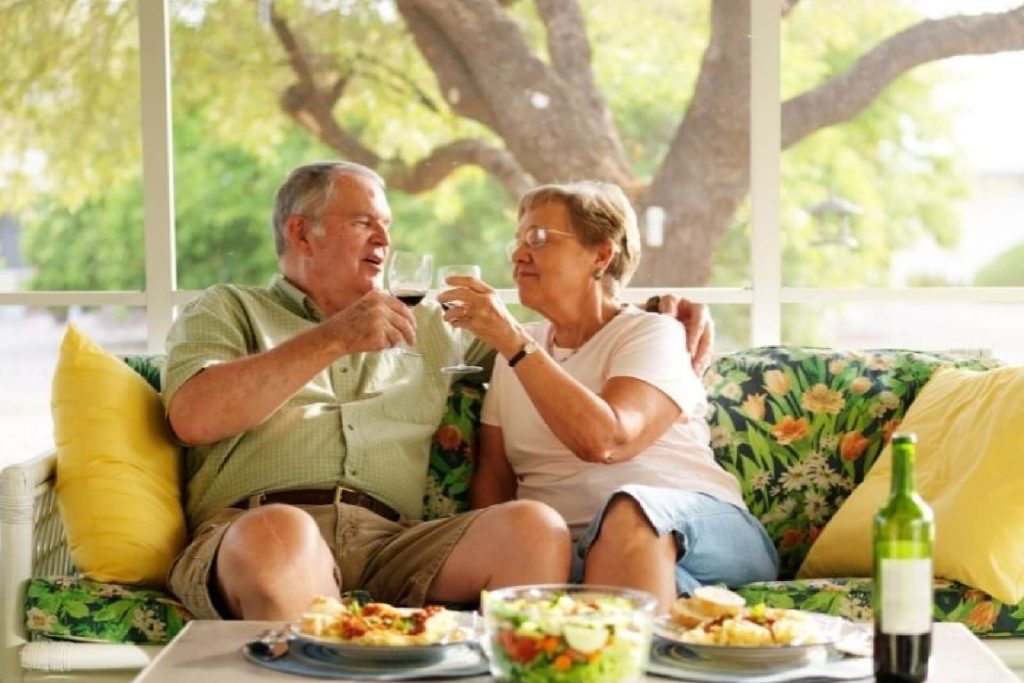 Senior couple smiling on couch